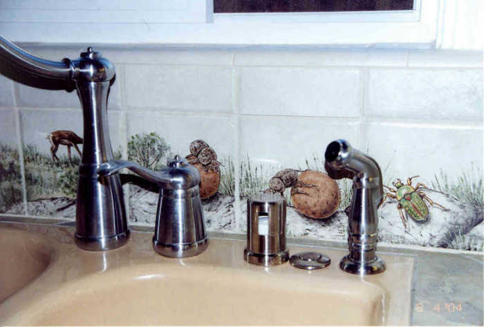 Dung beetles behind sink vignette shown in East African Wildlife kitchen wall tile mural by Julia Sweda.