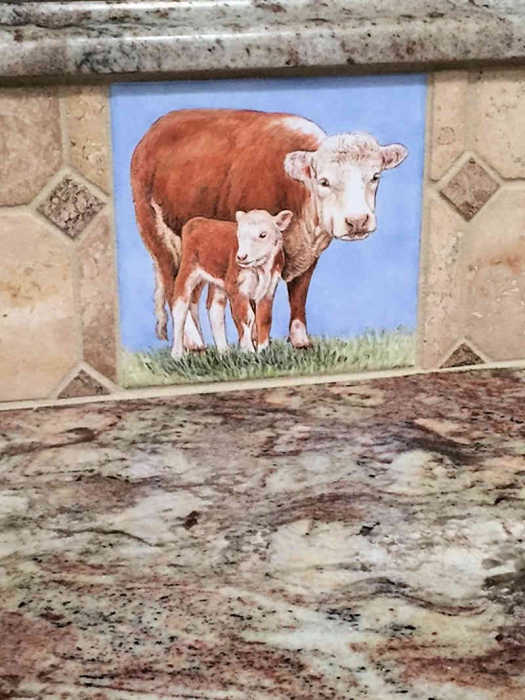 Annes Country Kitchen Animals, Hereford cow with her calf, portrait 2, installed in riser of countertop. Artist Julia Sweda.