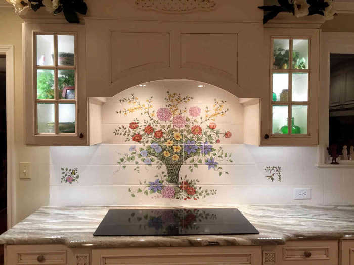 Mary Ellens Bouquet tile mural. Beautifully installed as a kitchen backsplash along with optional accent tiles.