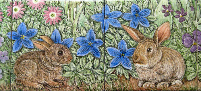 Closeup of adorable baby bunny rabbits in a backdrop of very colorful garden flowers. Artist Julia Sweda.