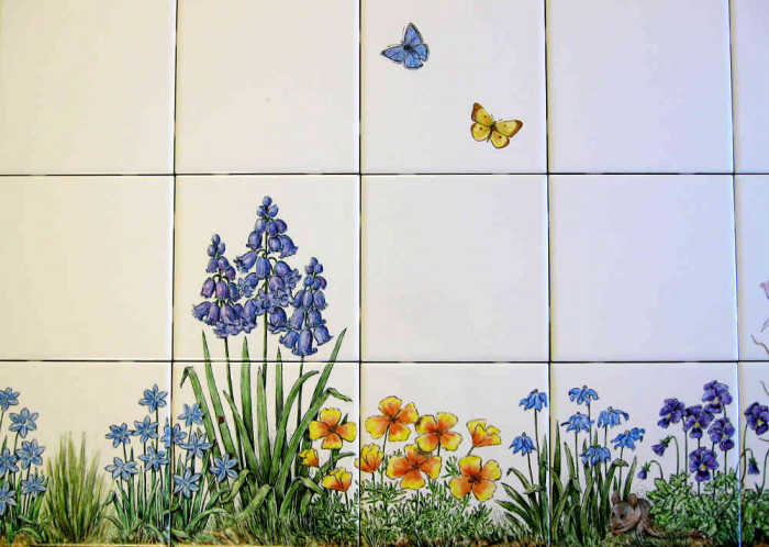 Skippers Floral Garden wall tiles mural, field mouse in foreground with California poppy, viola flowers. Hand painted tiles by Julia Sweda.