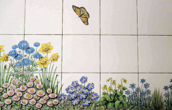 Skippers Floral Garden wall tiles mural, colorful Monarch butterfly fluttering above Baby Blue Eyes. Hand painted tiles by Julia Sweda.