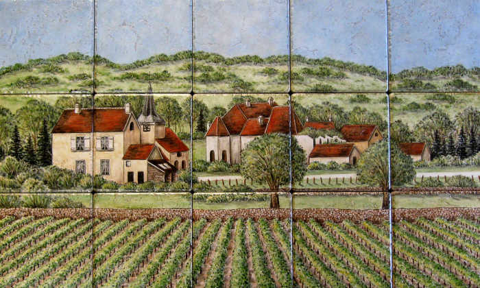 Pastoral village scene with quaint old homes. large rock walled vineyard in the Burgundy region of France.