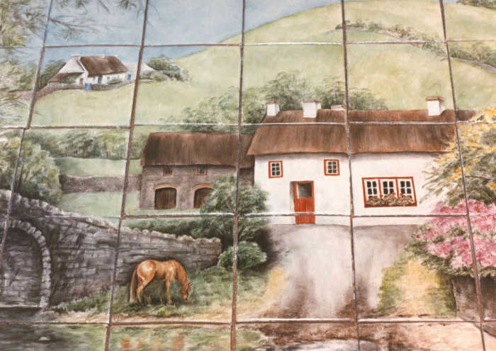 Julias Irish Countryside Cottages View 2, two white painted cottages and barn, lush green hillside in background, tile mural. Artist Julia Sweda.