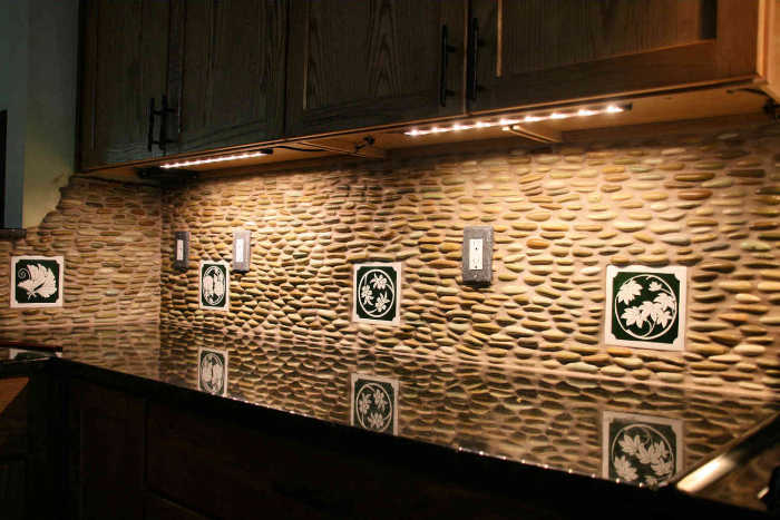Yukos Zen Garden Kamon Tiles Installed, kamon, emblem tiles installed as accents amongst the stone look field tiles. Artist Julia Sweda.