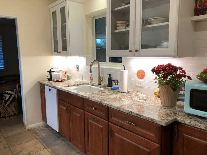 Second view of kitchen after completion of makeover. Portrait tiles interspersed with with subway tiles.