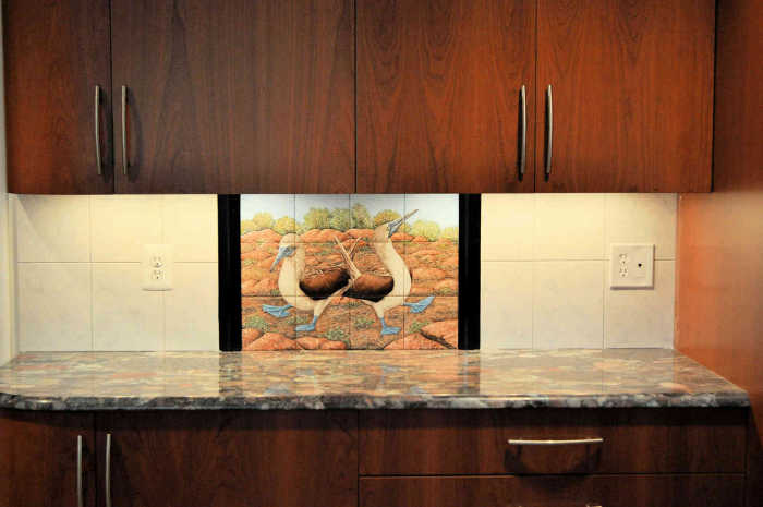 Blue Footed Boobies Mating and Courtship Dance painted tile mural installed as a backsplash in kitchen. Artist Julia Sweda.