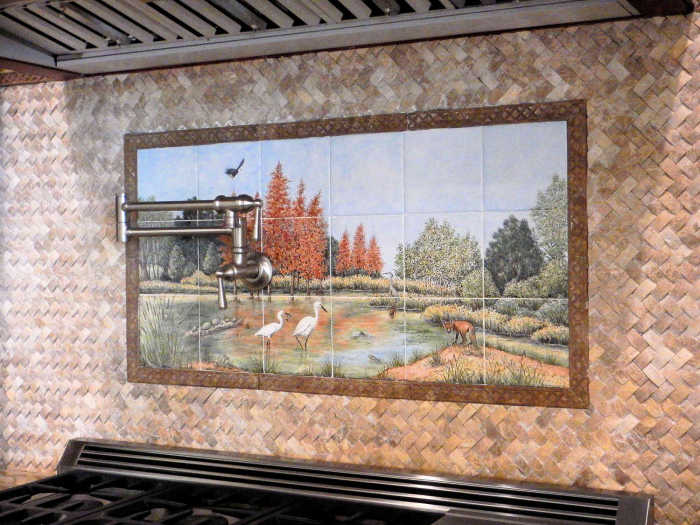 Snowy Egrets Bald Cypress Louisiana Swamp, tile mural installed as a backsplash with decorative border framing the painting. Artist Julia Sweda.
